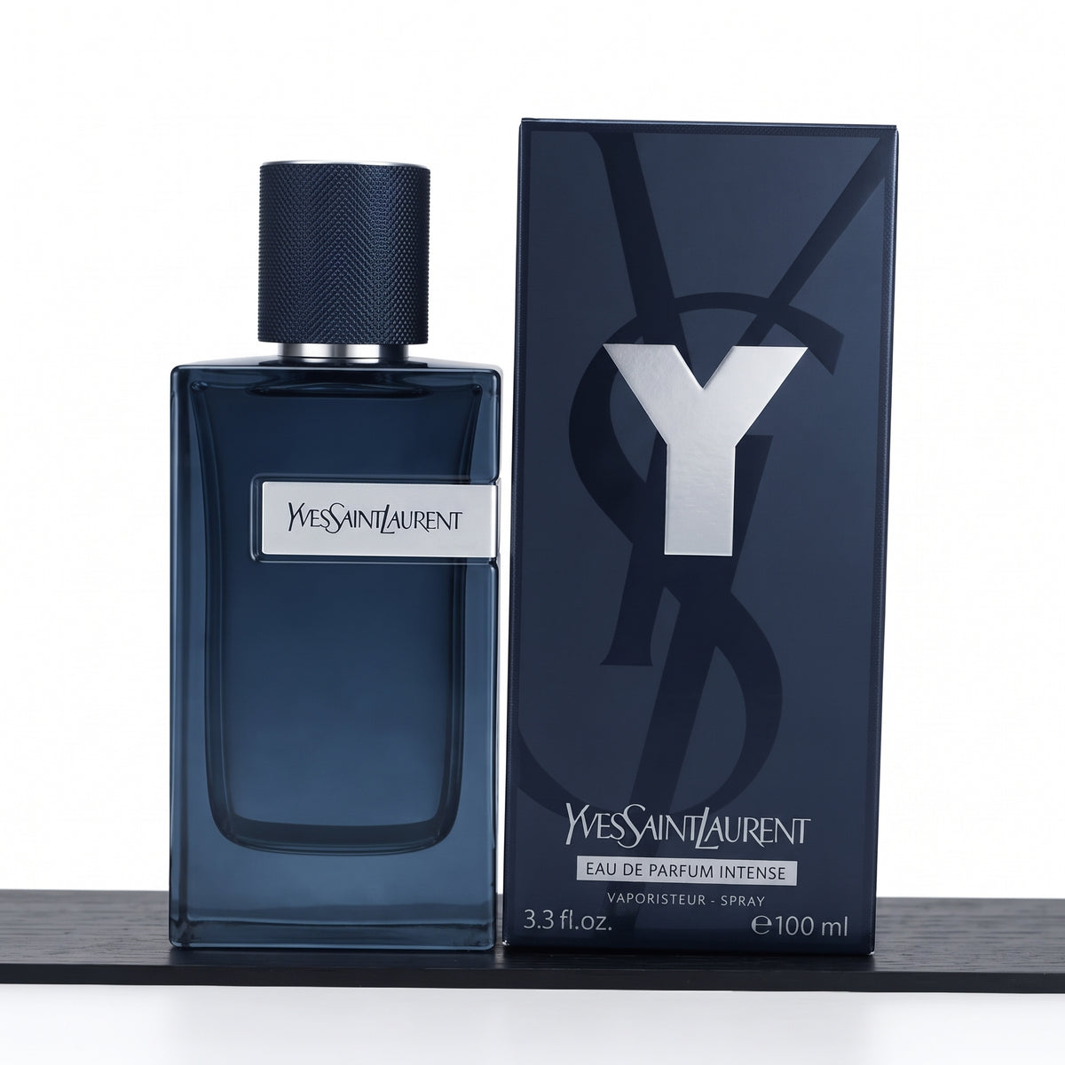 Yves Saint Laurent Modestel Intense Eau de Parfum 100ml bottle in dark blue glass next to its dark blue packaging box with a large silver Y logo.