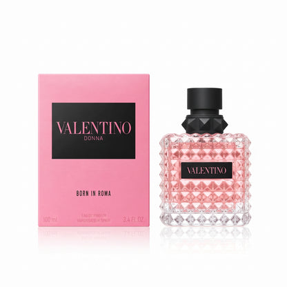 Valentino Donna Born in Roma perfume shown with its pink box and the textured glass bottle containing pink liquid, on a white background.