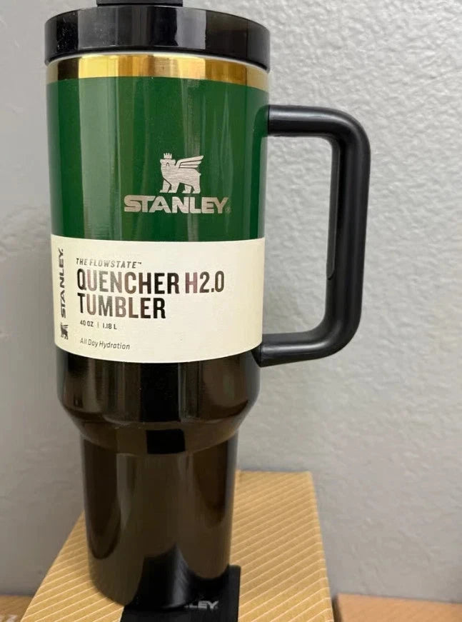 Stanley Quencher H2.0 tumbler on a wooden surface with a white wall background