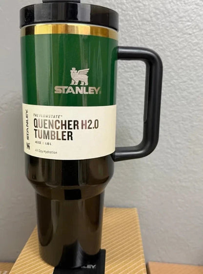 Stanley Quencher H2.0 tumbler on a wooden surface with a white wall background