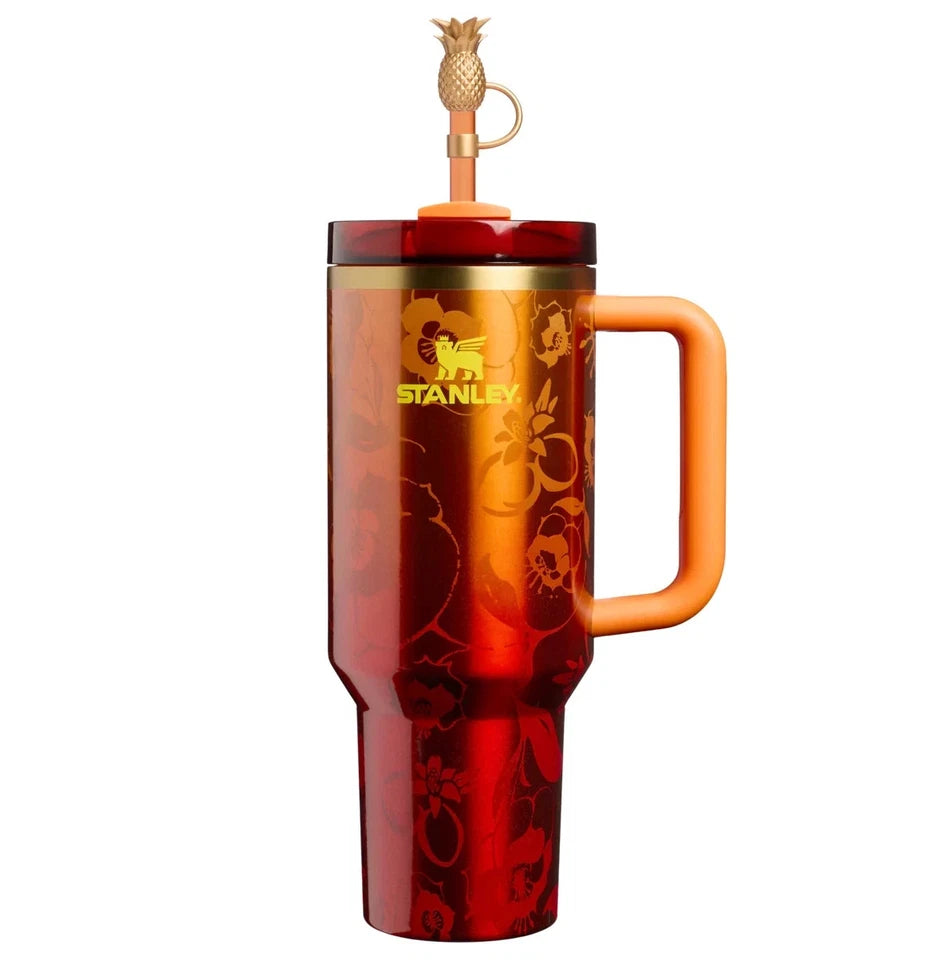 Red Stanley mug with a handle and pineapple-themed straw on a white background