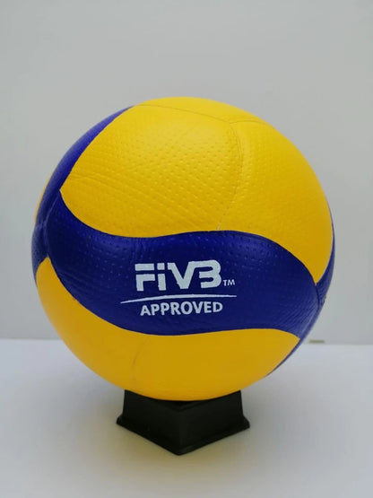 A yellow and blue FIVB approved volleyball displayed on a black stand against a plain white background.